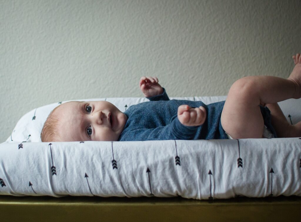 baby laying on a changing table