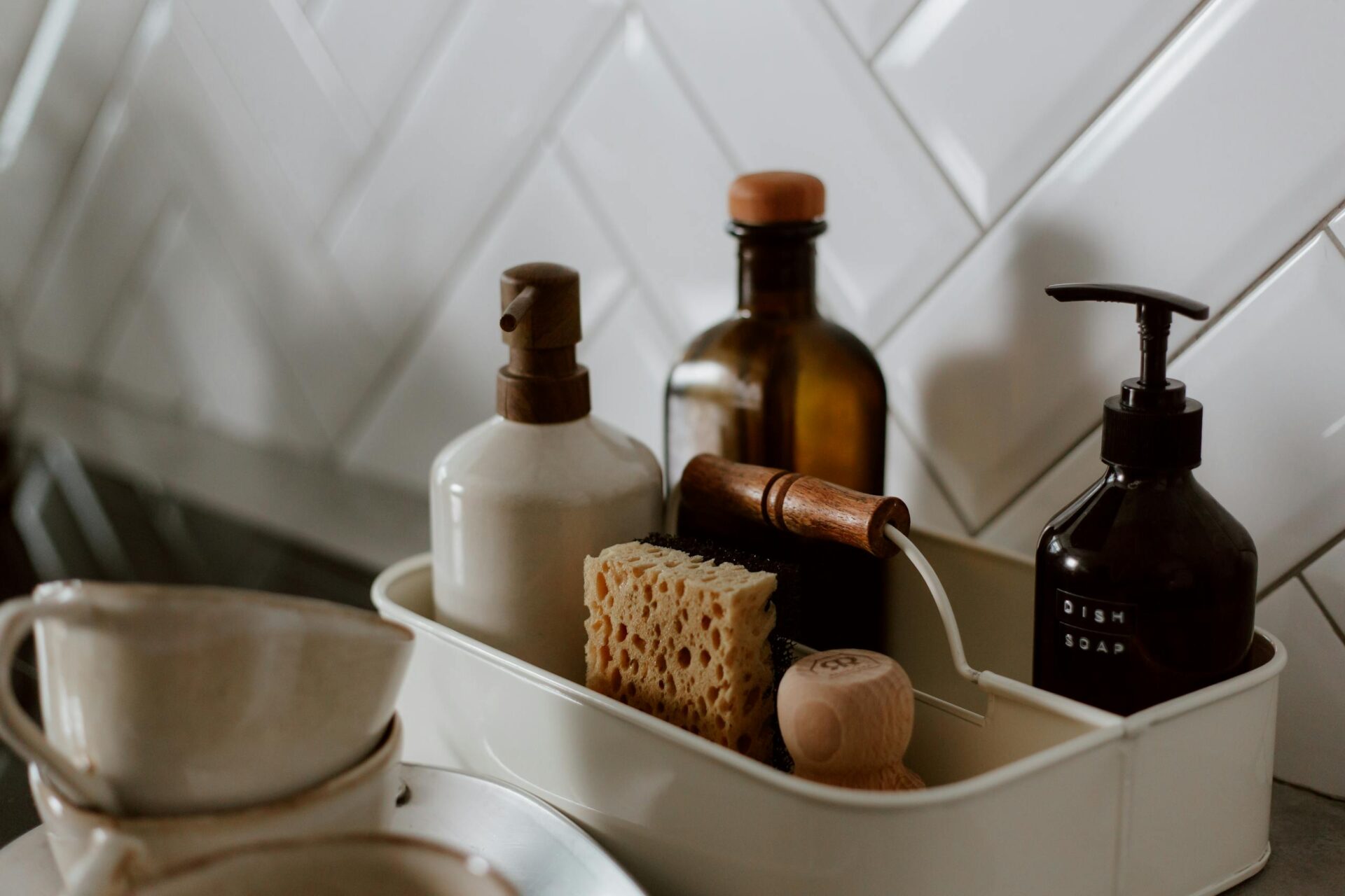 Close-up of chic kitchen spring cleaning essentials on a stylish countertop.