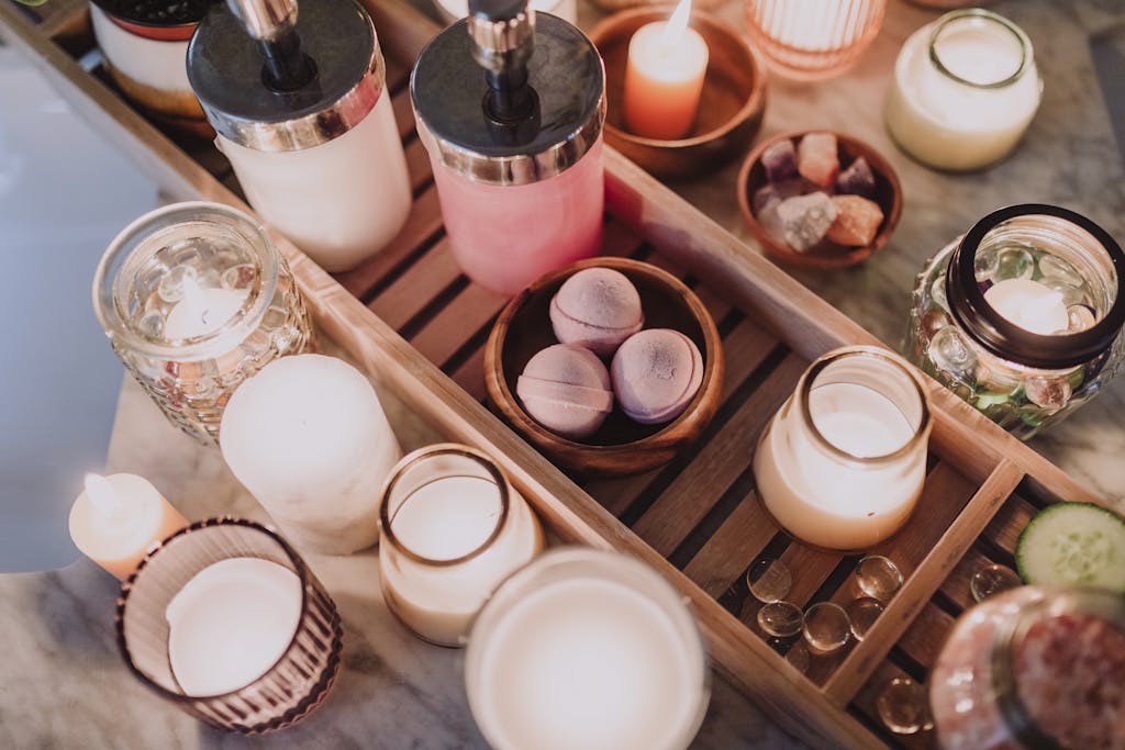 A cozy spa scene featuring candles, lotion, and essential oils for a relaxing atmosphere.