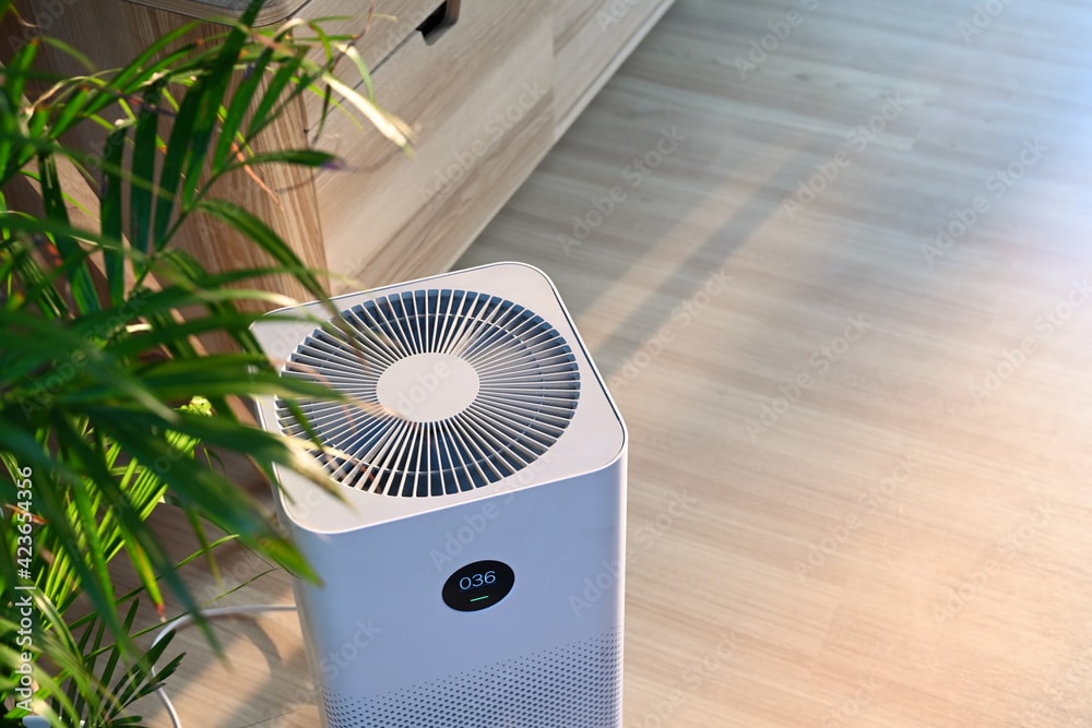 Air purifier on wooden floor in comfortable home. Fresh air and healthy life.
