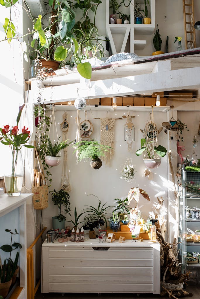Bright and cozy loft space featuring lush green plants, stylish decor, and natural sunlight.
