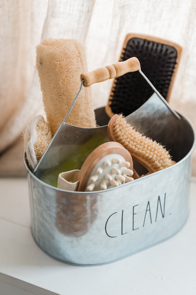 A variety of hygiene brushes arranged in a metal container labeled 'Clean'.