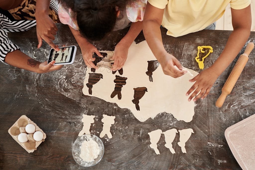 Children engaged in creative baking, making Easter-themed cookies together.