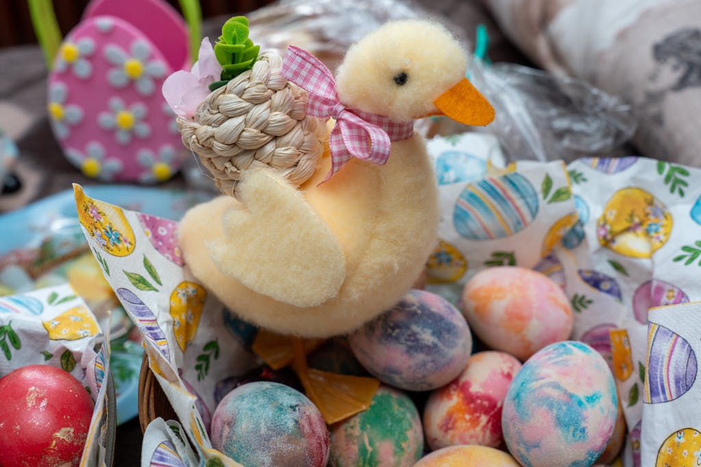 Festive Easter scene with a plush duck and vibrant decorated eggs in a basket.