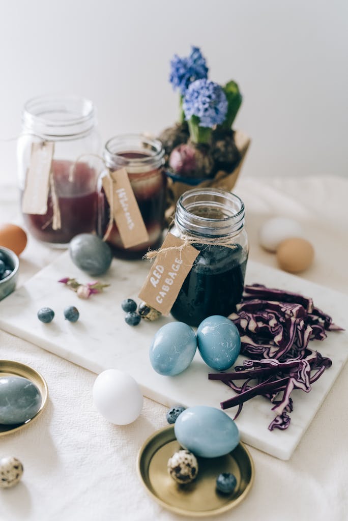 Natural Easter egg dyeing setup with red cabbage and hyacinths indoors.