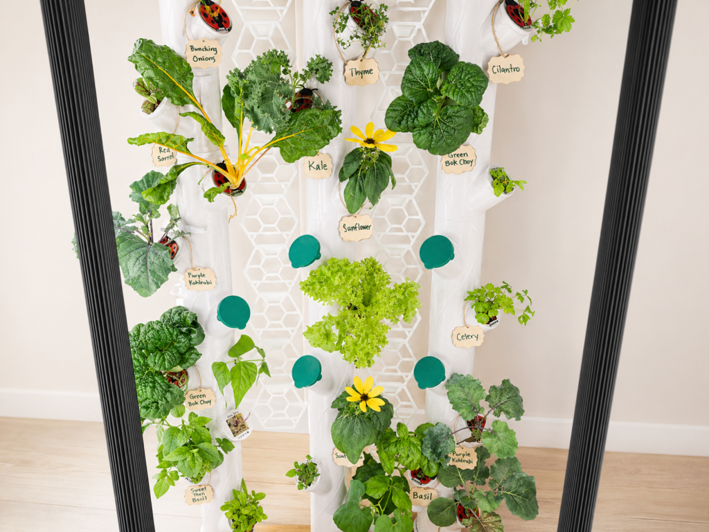 Gardyn smart indoor garden growing herbs, lettuce, kale, bok choy, and kohlrabi with vertical grow lights in a small home space.