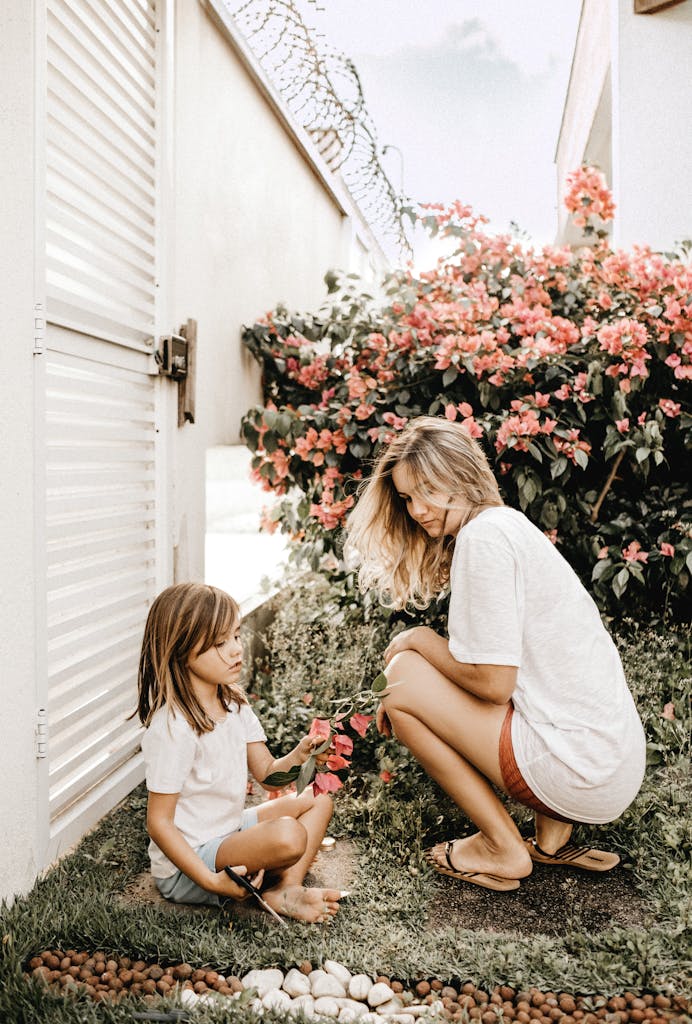 A mother and daughter bond in a vibrant garden filled with flowers, enjoying leisure time and non-toxic Mother's Day gifts