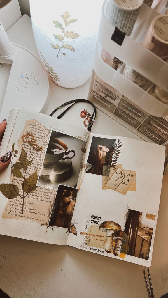 An artistic open journal with a creative collage and leaf artwork, perfect for inspiration.